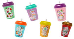 Six vibrant reusable cups with lids and straws, each featuring playful Disney-inspired designs and patterns reminiscent of shopDisney exclusives and Starbucks collectible ornaments, perfect for bringing a bit of theme park magic to your daily routine.
