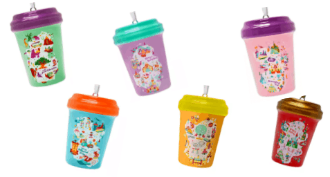 Six vibrant reusable cups with lids and straws, each featuring playful Disney-inspired designs and patterns reminiscent of shopDisney exclusives and Starbucks collectible ornaments, perfect for bringing a bit of theme park magic to your daily routine.