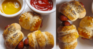 Four pigs in a blanket served with mustard and ketchup in small bowls on a white plate, perfect for fueling up before hitting the rides—these crowd-pleasing snacks are sure to be a favorite among theme park guests of all ages.