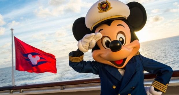 Mickey Mouse, dressed as a captain, stands on the deck of a Disney Cruise Line ship, saluting with a bright red flag nearby and the sparkling ocean behind him, capturing the excitement and adventure of setting sail with Disney.