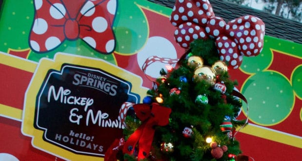 Celebrate the holidays at Disney Springs with a dazzling Christmas tree, topped with a signature red polka dot bow and sparkling with colorful Mickey-themed ornaments. The festive Mickey & Minnie sign in the background completes this must-see highlight of the beloved Christmas Tree Stroll, adding extra magic to your Disney holiday experience.