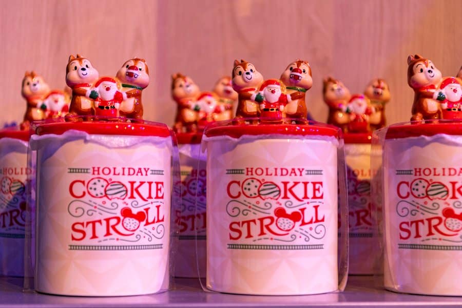 Holiday Cookie Stroll jars decked out with playful chipmunks and Santa figures on bright red lids line up in festive rows, channeling the joyful holiday energy of EPCOT’s iconic seasonal celebrations.