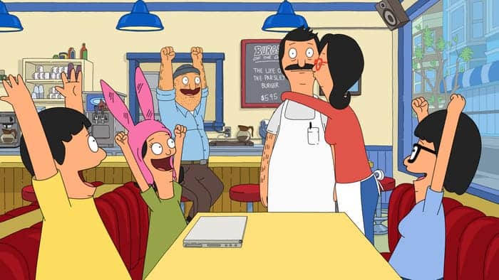 Animated family enjoying a lively meal at a Disney-themed diner; two kids cheer as their dad receives a loving kiss, with fellow guests celebrating nearby—capturing the magical spirit and joy of classic Disney park moments.
