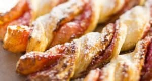 Strawberry Twists fresh from the Main Street Bakery at Disney Parks, their golden flaky layers bursting with sweet red strawberry filling and a dusting of powdered sugar—making every break between attractions just a little more magical.