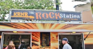 Guests line up to grab a bite at KRNR The Rock Station, now reopened at Disney’s Hollywood Studios, under its bold rock-inspired sign.