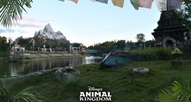 Expedition Everest’s snowy peak rises above a winding river and mysterious temple ruins in Disney’s Animal Kingdom, with vibrant prayer flags fluttering overhead and lush jungle greenery all around—captured in stunning detail with a Super Zoom Magic Shot.