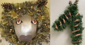 A lion-themed wreath adorned with festive tinsel and pinecones sits beside a giraffe-shaped wreath accented by patterned ribbon—both imaginative entries crafted by Disney Cast Members for a backstage holiday wreath-decorating contest.