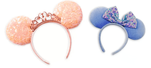 Magical headbands for Disney park-goers: a peach design topped with a regal crown, and the new blue style featuring a shimmery purple bow and glittering Minnie Mouse Ears—an enchanting accessory for exploring your favorite attractions. Find them at ShopDisney to upgrade your Disney adventure look.
