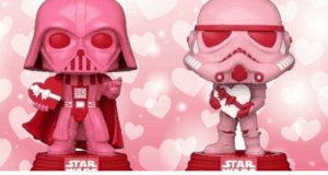 Two pink Star Wars Funko POPS holding hearts are displayed in front of a backdrop covered in pink and white hearts, capturing the spirit of Valentine’s Day for fans visiting Star Wars-themed attractions and entertainment venues.