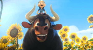 A cheerful girl enjoys an exciting ride on a friendly black bull through bright sunflower fields under sunny skies, capturing the spirited fun and adventure of Ferdinand as featured on Disney+.