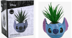 Add a bit of Disney magic to your home with this Stitch ceramic faux succulent planter, inspired by the fun and whimsy of Disney parks. Featuring Stitch playfully holding a lively green faux plant, this collector’s piece is shown in both its themed packaging and ready to display out of the box—perfect for fans looking to bring a touch of that Disneyland spirit into their space!.