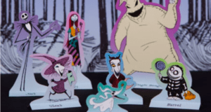 Jack Skellington, Sally, and four other vibrant characters from "The Nightmare Before Christmas" appear as colorful standees set amid a shadowy, enchanted forest scene—an immersive playset experience inspired by Tim Burton’s iconic world, perfect for fans to bring Halloween Town to life at home.