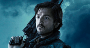 Cassian Andor, the hero from Disney+’s Andor series, stands confidently with a blaster over his shoulder against a dramatic blue sky—capturing the excitement of Star Wars adventures brought to life for fans everywhere.