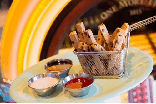 At Disney’s Beaches & Cream Soda Shop, Mickey Plant-Based Cookie Fries bring the fun with chocolate chip cookie sticks shaped like fries, served in a playful basket alongside three tasty dipping sauces—perfect for park guests looking for a delicious plant-based treat.
