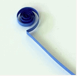 A blue paper strip twirls into a tight spiral like the frosty ice patterns found in a winter-themed parade float, displayed against a snowy white surface.