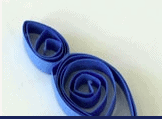 Blue paper quilling rolled into two spirals, one large and one small, set against a simple light background—evoking the enchanting winter magic of Frozen at Disney Parks and perfect for creating your own Arendelle-inspired crafts.