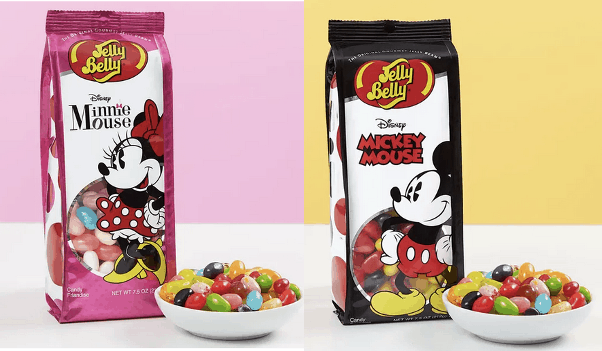 Minnie and Mickey Mouse are showcased on two Jelly Belly candy bags surrounded by a vibrant bowl of jelly beans, bringing classic Disney magic to this sweet treat display.