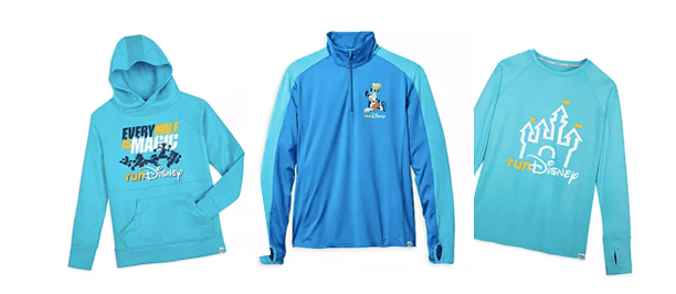 Level up your runDisney style with three blue shirts—a hoodie, a quarter-zip, and a long-sleeve—each showcasing distinct Disney-inspired graphics. These must-have pieces are perfect for Disney fans gearing up for race weekend and are available now on shopDisney.