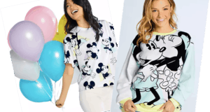 Disney fans radiate joy in matching Mickey Mouse shirts from shopDisney, with one holding pastel balloons as both smile brightly—capturing the magic and playful spirit of the parks.