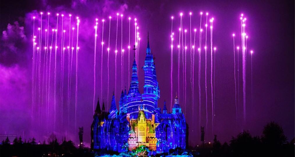 Drones light up the night sky with "EPCOT 40" above Spaceship Earth, which glows vibrantly alongside World Showcase pavilions under a purple sky—capturing the same wow factor guests experienced at Shanghai Disney Resort's Fifth Anniversary drone spectacular.