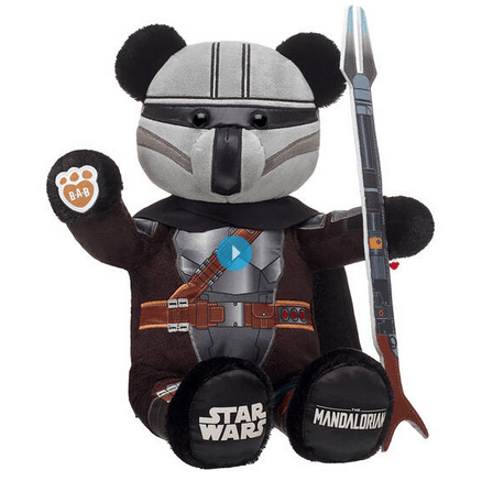 Experience the magic of Build-A-Bear Workshop with a plush bear dressed as The Mandalorian from Star Wars, complete with its own toy staff and the iconic Star Wars logo on its paw. This huggable collectible is an ideal souvenir for Star Wars fans visiting our entertainment destination.