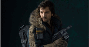 A Star Wars: Andor character in a fur-lined parka poses with a blaster against a dramatic, moody backdrop, capturing the immersive and gritty atmosphere of the galaxy far, far away experienced at Star Wars-themed attractions.