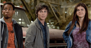 Three adventurous teens pose in front of a classic red truck, channeling the spirit of Percy Jackson as if they're gearing up for an epic quest straight out of a hit adventure series—perfect cast members for an immersive theme park experience.