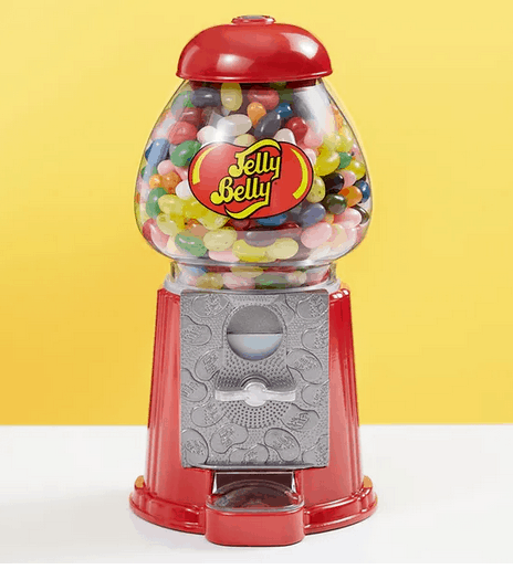 A vibrant red Jelly Belly jellybean machine overflowing with colorful jelly beans, set against a cheerful yellow backdrop, showcases whimsical Minnie and Mickey Mouse designs for an extra sprinkling of Disney magic—perfect for fans visiting the happiest place on earth.