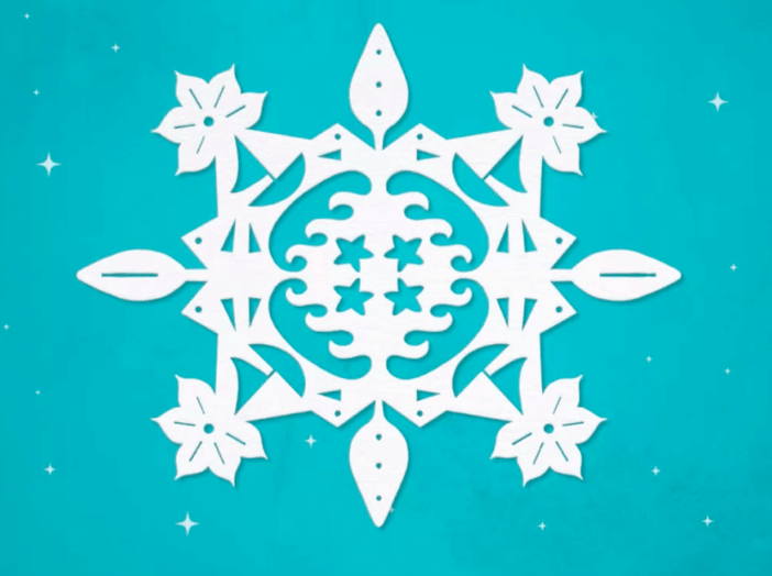 Intricately cut white paper snowflake featuring star and leaf designs, set against a vibrant turquoise backdrop sprinkled with tiny white stars—evoking the dazzling, magical atmosphere of a winter-themed parade or holiday event at your favorite theme park.
