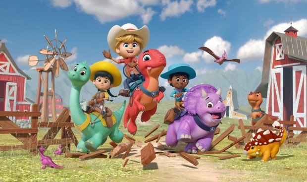 Kids experience the excitement of Dino Ranch as they ride vibrant dinosaur characters through a wooden fence on a lively farm, surrounded by barns and soaring birds—bringing the beloved Disney Junior series to life in an immersive attraction setting.