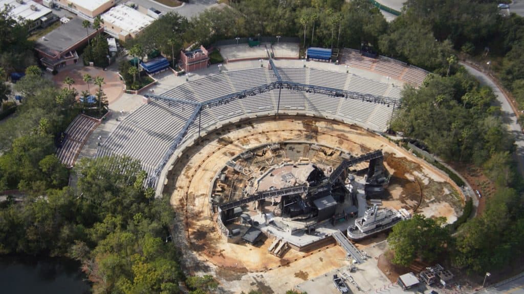 A sweeping aerial view of the Fantasmic amphitheater at Disney's Hollywood Studios reveals ongoing stage updates and empty tiered seating, building excitement among fans for a refreshed version of the beloved nighttime spectacular.