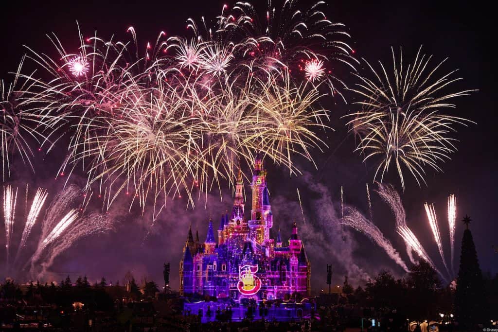 Fireworks dazzle over the iconic Enchanted Storybook Castle at Shanghai Disney Resort, all aglow for the park’s spectacular Fifth Anniversary celebration, as the commemorative anniversary logo shines brightly amid the festivities.