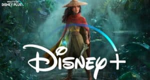 Raya from Disney’s Raya and the Last Dragon, dressed in her iconic hat and wielding her sword, stands ready for adventure in a lush jungle backdrop, with the Disney+ Premier Access logo featured prominently in front of her.