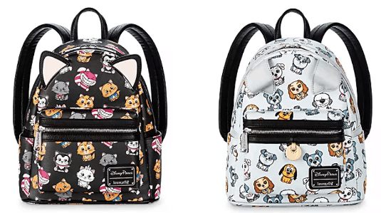 Two playful Loungefly backpacks inspired by your favorite theme park animal pals—one in classic black, one in crisp white—each with 3D ears and whimsical faces, adorned with charming cartoon prints of beloved dogs and cats straight from the Disney universe.