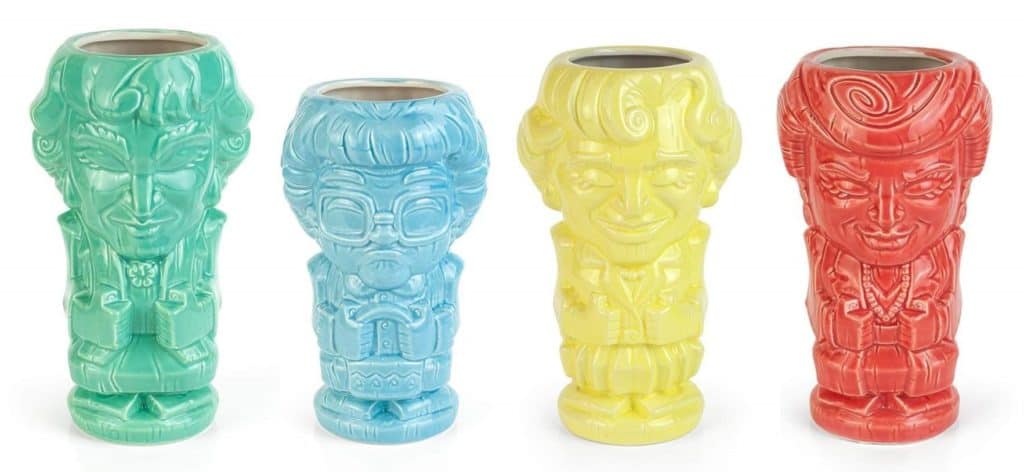 Four vibrant ceramic mugs, each crafted to resemble a playful, cartoon-style Golden Girls character in their signature colors—an ideal collectible for Geeki Tikis and pop culture fans visiting your favorite theme park shop.