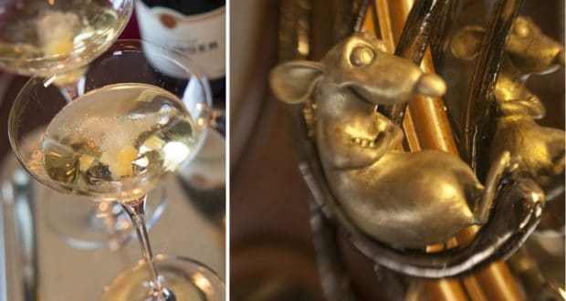 Two champagne flutes sit beside a close-up of a gold Remy sculpture with a mischievous grin, capturing the whimsical spirit of Remy’s on Disney Cruise Line and highlighting the signature elegant, playful atmosphere fans love.