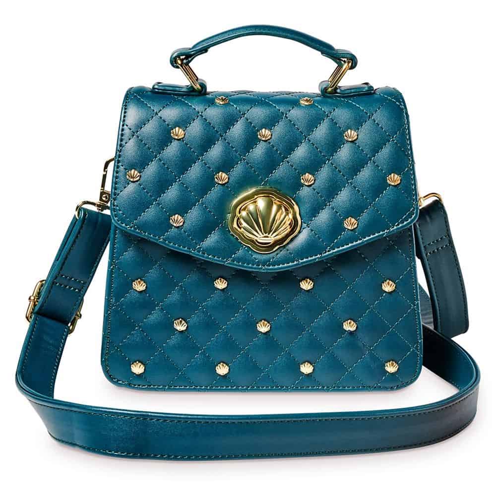 Teal quilted handbag featuring gold seashell studs, a top handle, and adjustable shoulder strap—an enchanting accessory inspired by Ariel, perfect for showing off Disney style at Magic Kingdom or while exploring Disney Springs. Shop now at shopDisney.