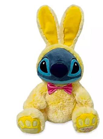 Stitch plush dressed in a yellow bunny suit with pink bow tie and matching yellow bunny ears, ready for an Eggstravaganza at Disney parks—an irresistible collectible for Stitch fans and Disney Easter celebration lovers.