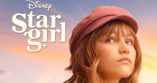 Disney Stargirl shines on a pastel sky backdrop, wearing her signature pink hat and radiating the whimsical, feel-good energy fans love from the Disney+ sequel.