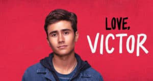 Victor from Disney+’s “Love, Victor” stands in front of a vibrant red backdrop, bringing the hit series to life for fans of Disney’s beloved entertainment.