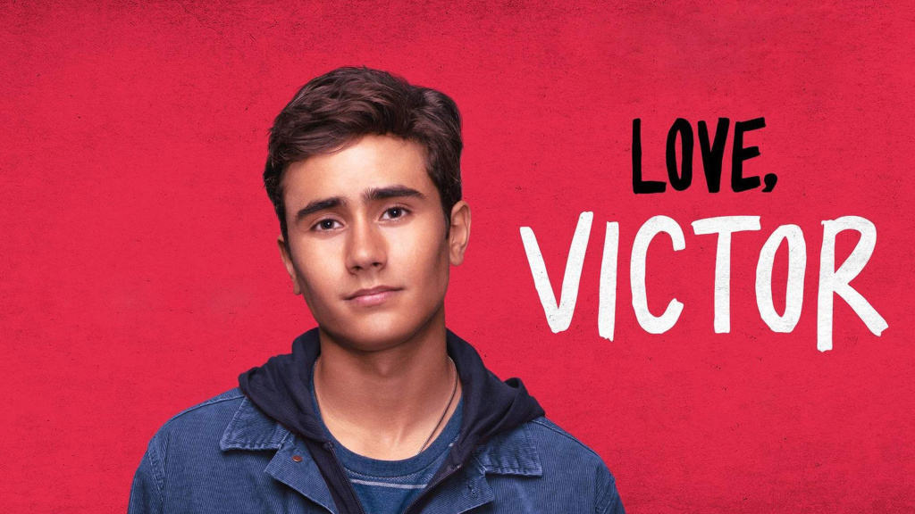 Victor from Disney+’s “Love, Victor” stands in front of a vibrant red backdrop, bringing the hit series to life for fans of Disney’s beloved entertainment.