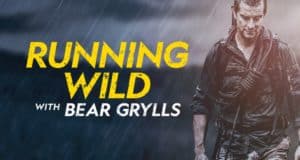 Bear Grylls, drenched and adventurous, stands in the pouring rain beside the bold "Running Wild with Bear Grylls" logo on a dramatic dark backdrop, building anticipation for thrilling new episodes.