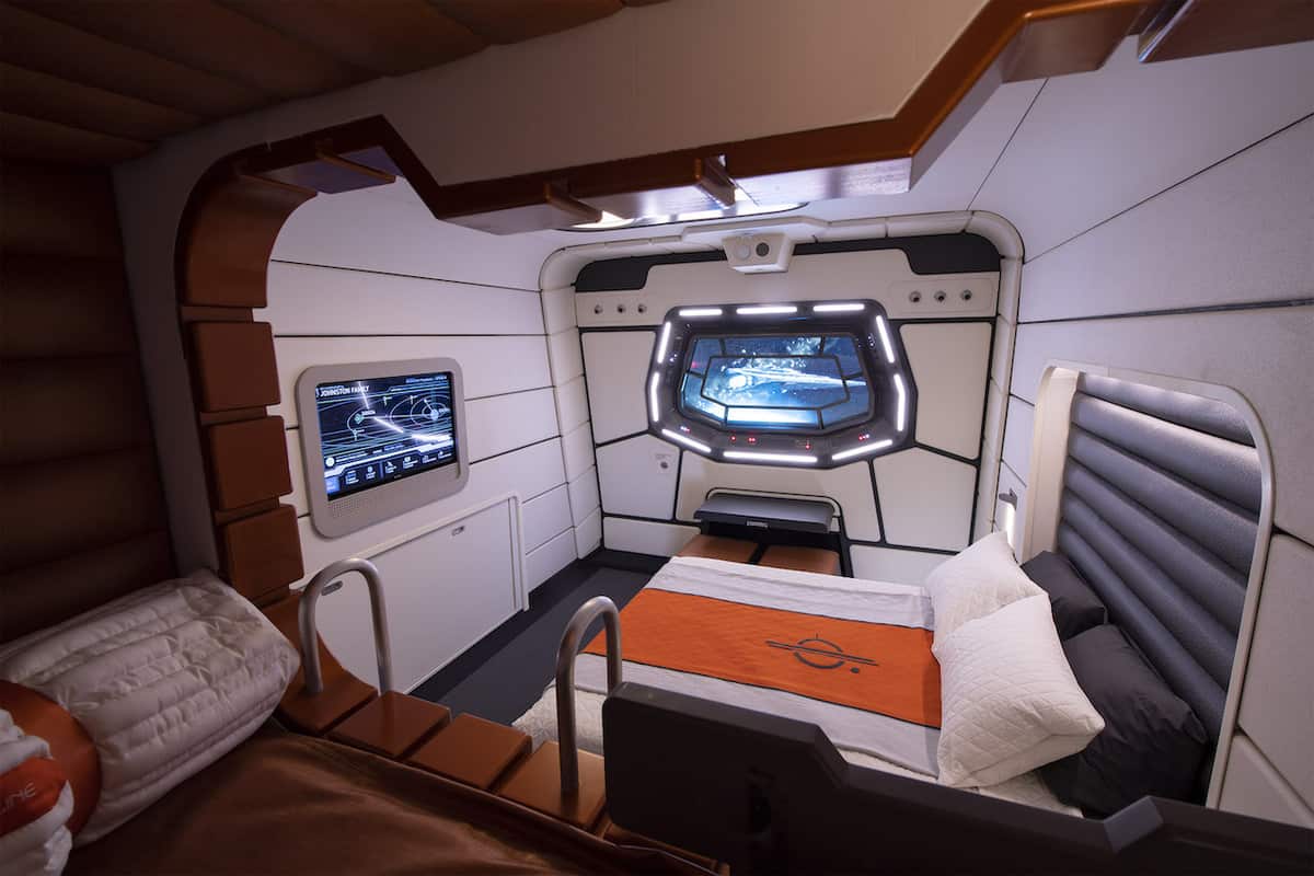 Star Wars: Galactic Starcruiser hotel room featuring a space-inspired window, interactive display screens, and sleek modern bed, capturing the fully immersive atmosphere curated by the Hotel Services Director for fans seeking an out-of-this-world Disney experience.