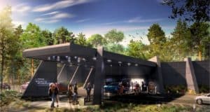 Guests gather outside the sleek, Star Wars: Galactic Starcruiser hotel, surrounded by lush trees and parked vehicles, eagerly awaiting their next adventure or guidance from the Hotel Services Director before entering this immersive Disney experience.