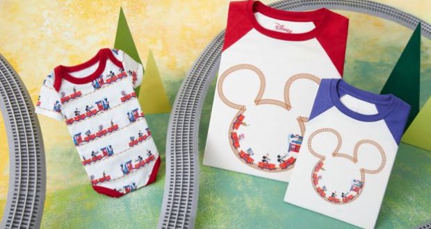 A vibrant display features three Mickey Mouse-themed shirts adorned with charming train graphics, surrounded by playful toy train tracks on a colorful backdrop. Inspired by the whimsical atmosphere of Mickey & Minnie's Runaway Railway at Disney Parks, this setup is perfect for BoxLunch guests and Disney enthusiasts seeking magical merchandise from their favorite attraction.