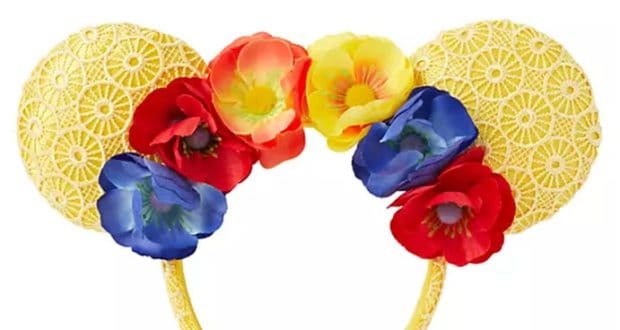 Add a playful pop of color to your Disney Parks adventure with this vibrant yellow lace Minnie Mouse floral ear headband, adorned with cheerful red, yellow, and blue flowers—perfect for celebrating springtime magic at the parks.