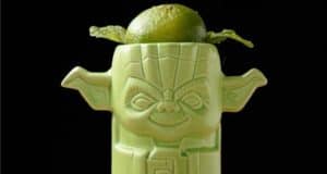 A Yoda-shaped cup garnished with lime and mint, glowing against a dark backdrop—an eye-catching Star Wars drinkware collectible perfect for sipping your Dagobah Float while exploring Galaxy’s Edge.