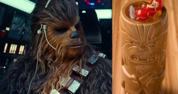 Chewbacca at Galaxy’s Edge relaxes in the Millennium Falcon cockpit beside a tropical tiki mug garnished with cherries, enjoying a signature Wookiee cocktail on a rustic wooden console.