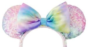 Colorful pastel rainbow sequin Minnie Mouse ears headband with a coordinating pastel bow at the center, sparkling with magic just like your favorite Disney Parks accessories. This dazzling Sequin Ear Headband is an ideal must-have for Disney fans, adding whimsical flair to your next visit or shopDisney collection.