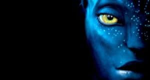 A close-up of a Na’vi face with vivid blue skin, a luminous yellow eye, and intricate white dots stands out against a deep black background, capturing the mesmerizing look of Pandora from Avatar—just like stepping into Disney’s Pandora – The World of Avatar.